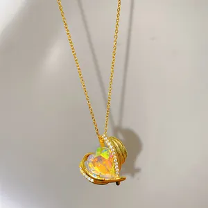 Detailed close-up of golden titanium steel heart necklace featuring iridescent crystal facets