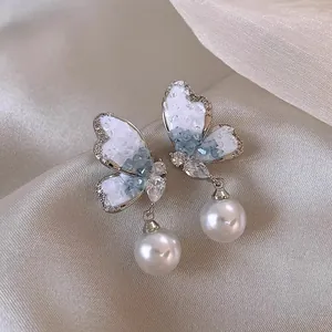 French luxury style butterfly stud earrings with elegant white pearl drops for women