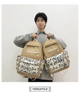 Large khaki backpack featuring a stylish black and white graffiti print for students.