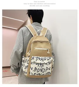 Back view of durable khaki student backpack featuring stylish black and white graffiti print details