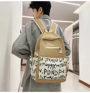 Back view of a trendy khaki high-capacity student backpack with graffiti pattern detail.