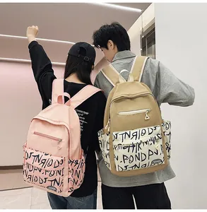 Casual stylish backpacks with graffiti pattern detail worn by young couple outdoors
