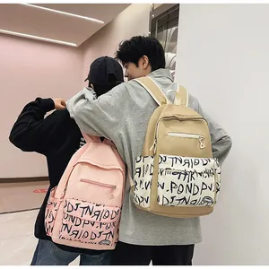 Couple wearing high-capacity trendy student backpacks in pink and khaki for daily travel
