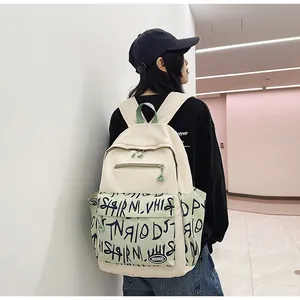 Modern large capacity student backpack with green graffiti print shown on fashion model