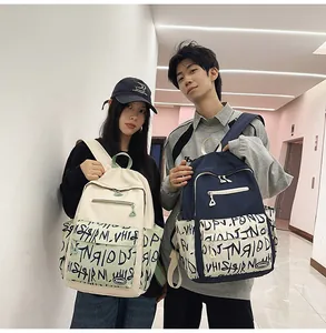 Two students posing with trendy large-capacity backpacks featuring unique graffiti patterns