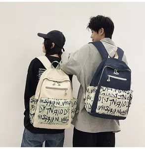 Student graffiti backpacks in navy and cream colors shown on models for school use.