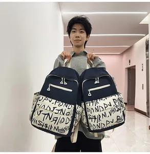 Detailed view of trendy large capacity navy blue backpack featuring unique graffiti print held by model