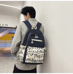 Detailed side view of a fashionable navy graffiti backpack worn by a male model