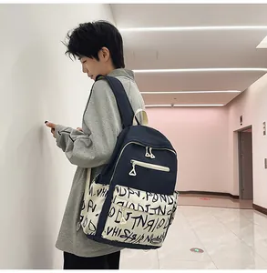 Side view of student wearing navy and graffiti print casual large capacity backpack