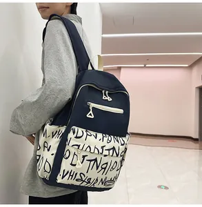 Side view of a person wearing a navy blue and graffiti print large capacity backpack