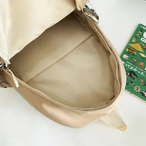 Spacious interior of a large capacity beige student backpack with compartment