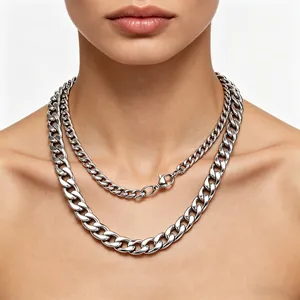 Detailed view of chunky silver stainless steel Cuban link necklaces on a model.