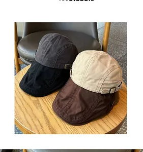 Close-up detail of retro cotton ivy caps in various earth tones on a wooden table display