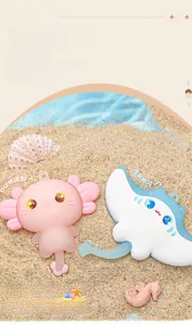 Macro detail of cute axolotl and manta ray keychains with sparkling glass eyes