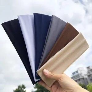 Multi-color set of 7cm wide elastic sports headbands held in a fan shape outdoors.