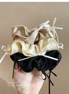 Close-up of balletcore satin scrunchies with elegant ribbon bows in various colors