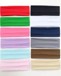 Selection of 12 solid color 7cm wide elastic sports headbands for yoga and fitness