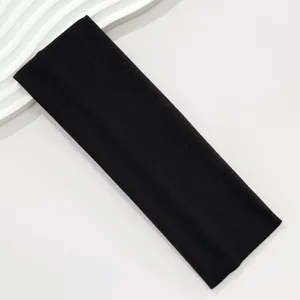 Close-up view of a wide black elastic headband for sports and yoga exercises.
