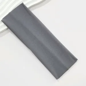 Close-up detail of a wide grey elastic headband made from soft and breathable fabric