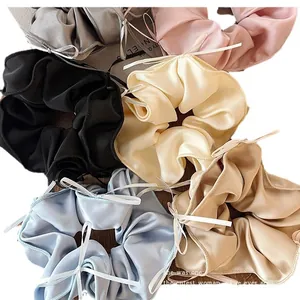 Premium balletcore satin hair scrunchies with white ribbon bows in assorted elegant colors