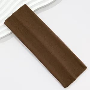 Macro view of a 7cm wide coffee brown elastic sports headband with soft knit texture