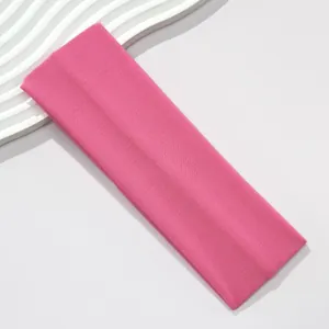 Close-up view of a rose pink 7CM wide high-elasticity sports headband with knit texture