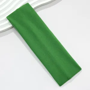 Detail view showing the fine knit texture of the green wide elastic sports headband.