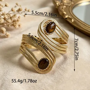 Vintage gold-tone geometric cuff bangle with oval brown stones and size measurements