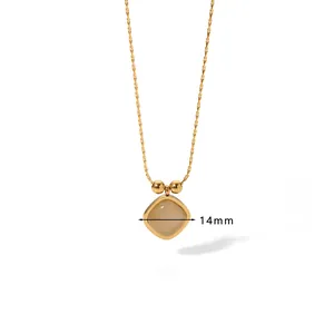 Detailed view of a 14mm cat eye stone pendant on a gold titanium steel necklace