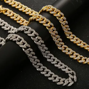 Detailed macro view of gold and silver iced out Cuban link necklaces with rhinestones