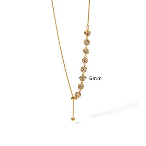 Detailed macro view of gold titanium steel necklace featuring 6mm clear cubic zirconia stones