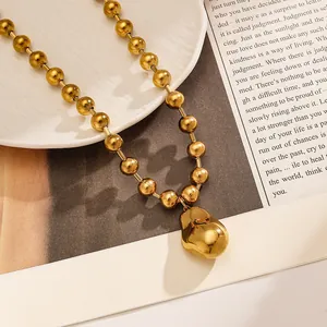 Macro view of gold plated stainless steel ball chain necklace with large irregular pendant