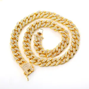 Detailed macro shot of a gold-plated Cuban link necklace with sparkling rhinestone pavé