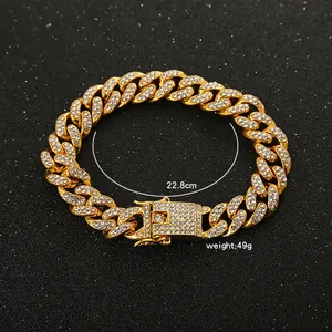 Iced out gold Cuban link bracelet 22.8cm length detail with weight 49g shown on black