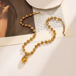Close-up detail of the 18k gold plated stainless steel necklace with teardrop charm.