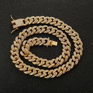 Close-up of iced out gold Cuban link chain necklace with sparkling rhinestones
