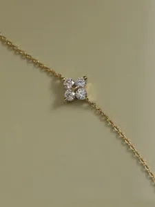 Close-up of a gold-plated sterling silver four-leaf clover anklet with cubic zirconia
