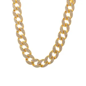 Detailed view of heavy gold-tone Cuban link necklace fully iced out with white rhinestones