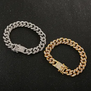 Detailed view of gold and silver iced out Cuban link chains with shimmering rhinestones