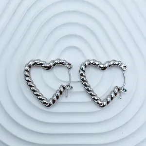 Detail view of elegant silver twisted heart hoop earrings in polished stainless steel.