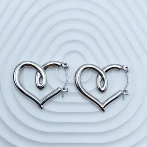 Detailed view of silver heart-shaped stainless steel hoop earrings with unique inner loop