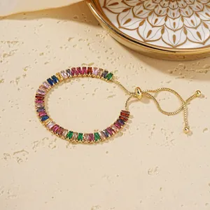 Close-up of gold-plated bracelet with multi-color baguette-cut cubic zirconia stones