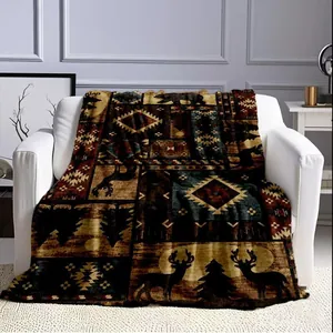 Rustic southwestern style throw blanket with bear and deer patterns on a white armchair