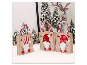 Detailweergave van drie kerst gnome jute cadeauzakjes met feestelijke handvaten