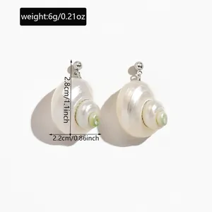 Detailed view of natural conch shell earrings showing weight and dimensions info