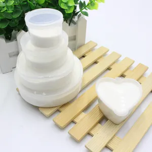 Different sized containers showcasing the texture of fluffy white artificial snow powder