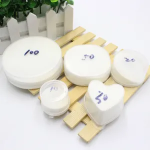 Detailed view of artificial snow powder sets in various round and heart shaped containers