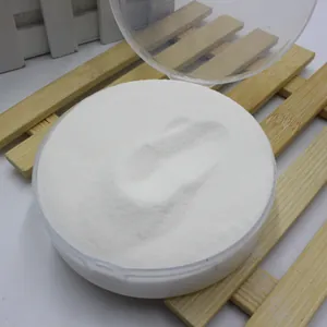 Detailed close-up view of white artificial snow powder in a clear round plastic container.