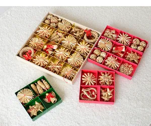 Handmade straw Christmas tree ornaments in various shapes and gift boxes.