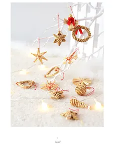 Close-up of handmade straw woven Christmas ornaments on white festive branches